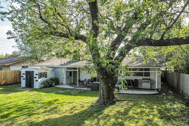 4620 S Winston Ave, Tulsa, OK 74135 - rear view of property with a fenced backyard, a storage unit, and a patio area