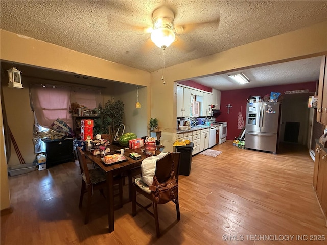 53801 S 355th Rd, Maramec Twp, OK 74045 - dining area featuring light wood-style flooring, a textured ceiling, and a ceiling fan