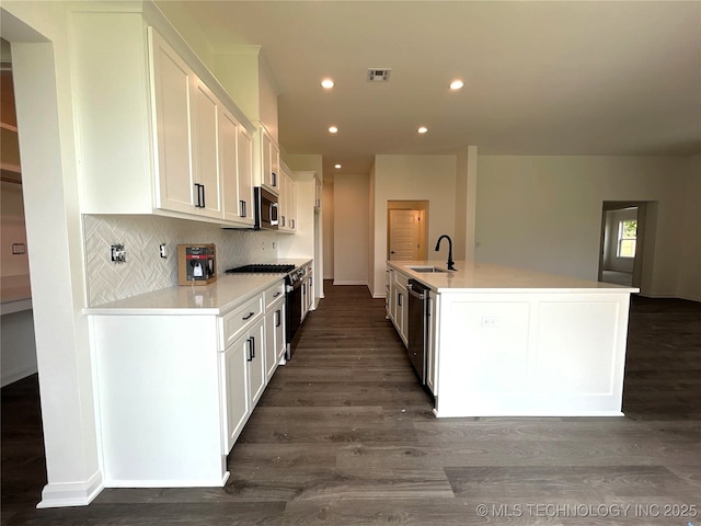 10416 E 132nd St S, Bixby, OK 74008 - kitchen featuring appliances with stainless steel finishes, dark wood-style floors, white cabinetry, recessed lighting, and light countertops