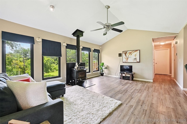 3104 Howard St, Sand Springs, OK 74063 - living room with a wood stove, a ceiling fan, wood finished floors, and lofted ceiling