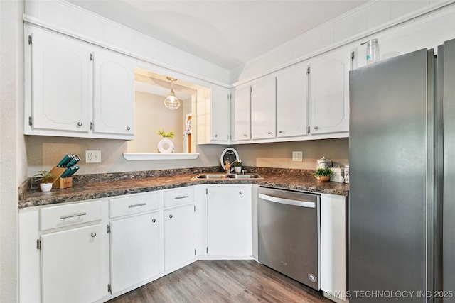 3104 Howard St, Sand Springs, OK 74063 - kitchen featuring appliances with stainless steel finishes, dark countertops, white cabinets, and wood finished floors