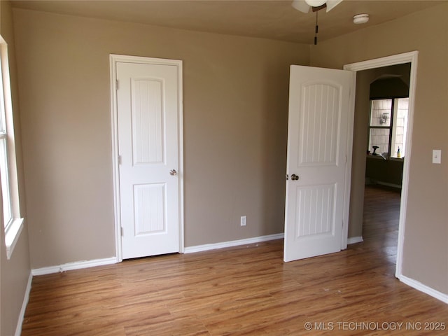 2131 Topeka St, Muskogee, OK 74403 - unfurnished bedroom with light wood-style flooring and arched walkways