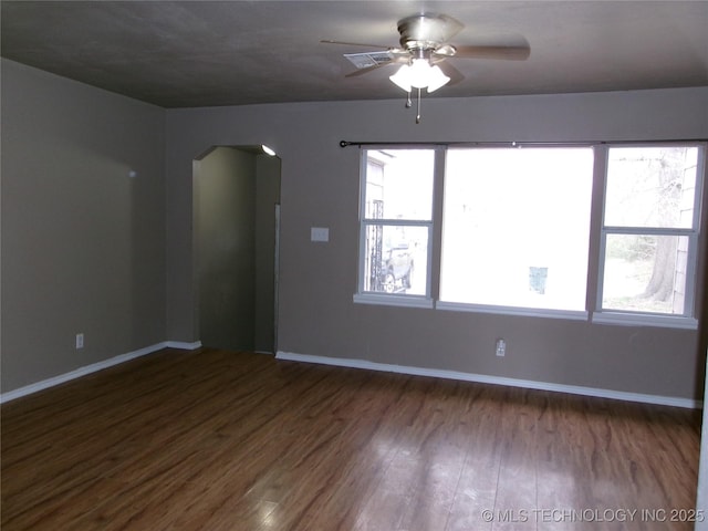 2131 Topeka St, Muskogee, OK 74403 - unfurnished room featuring arched walkways, ceiling fan, and wood finished floors