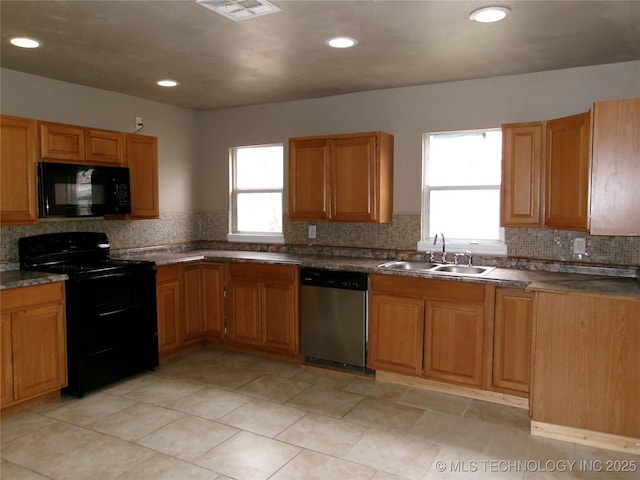 2131 Topeka St, Muskogee, OK 74403 - kitchen with black appliances, backsplash, dark countertops, and recessed lighting