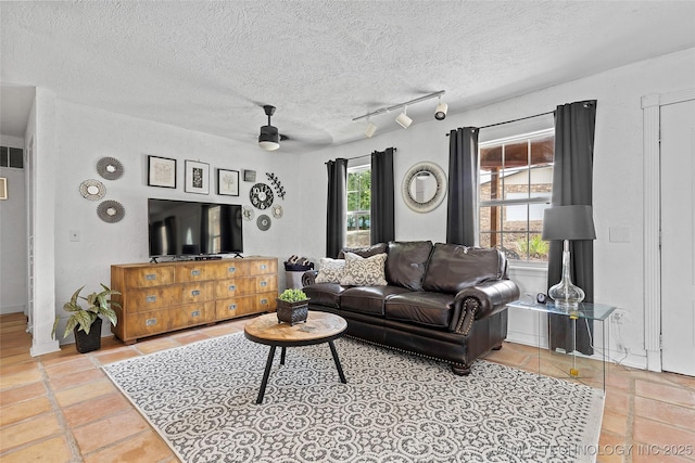4080 Bud Dr, Sulphur, OK 73086 - tiled living area featuring a textured ceiling, a ceiling fan, and track lighting