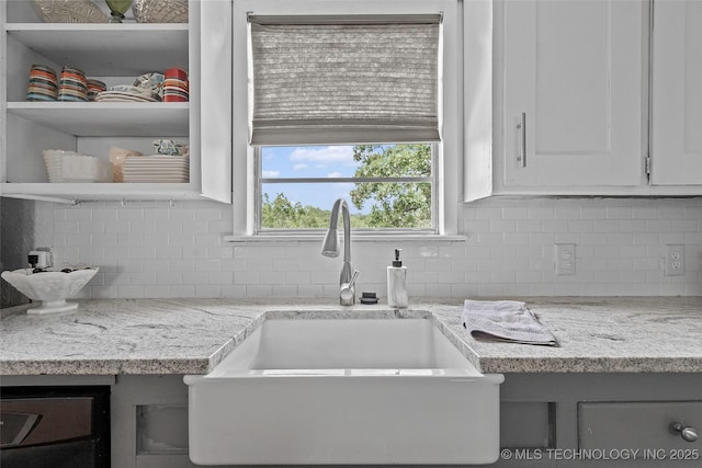 4080 Bud Dr, Sulphur, OK 73086 - kitchen featuring backsplash, white cabinetry, and light stone countertops
