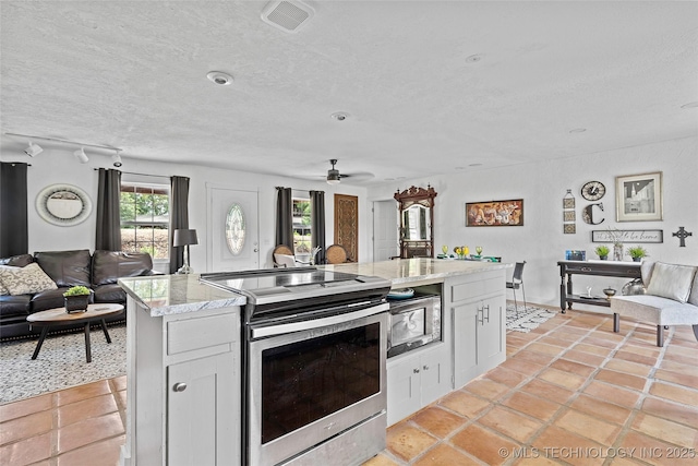 4080 Bud Dr, Sulphur, OK 73086 - kitchen with open floor plan, electric stove, white cabinets, a textured ceiling, and ceiling fan