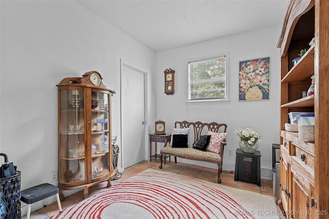4080 Bud Dr, Sulphur, OK 73086 - sitting room with light tile patterned floors and a wood stove
