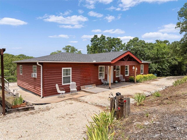 4080 Bud Dr, Sulphur, OK 73086 - back of house with log veneer siding and a shingled roof