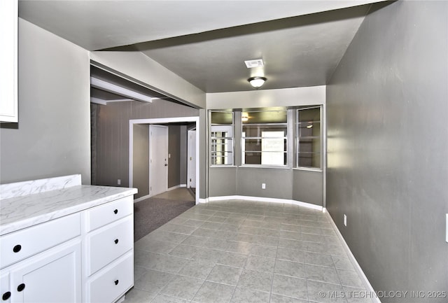 10046 E 29th St, Tulsa, OK 74129 - spare room featuring light tile patterned flooring and baseboards