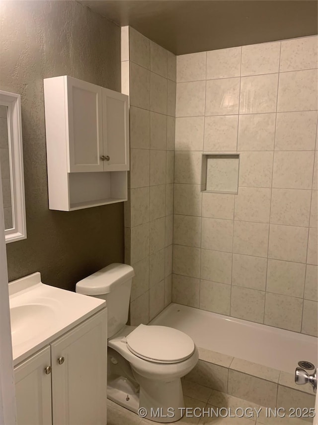 10046 E 29th St, Tulsa, OK 74129 - bathroom featuring vanity, a textured wall, and a tile shower