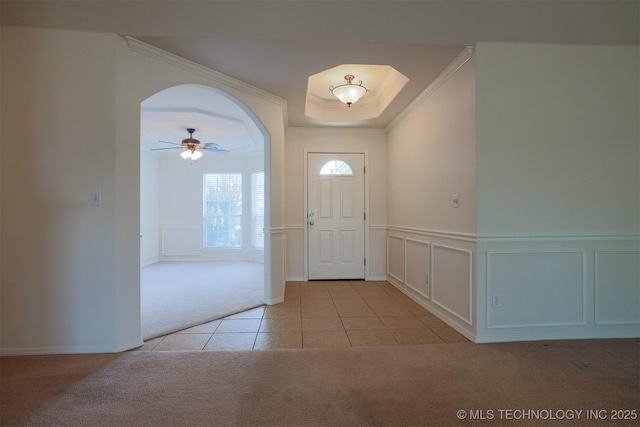 9904 N 102nd E Ave, Owasso, OK 74055 - foyer entrance with light colored carpet, light tile patterned flooring, a decorative wall, a ceiling fan, and a wainscoted wall