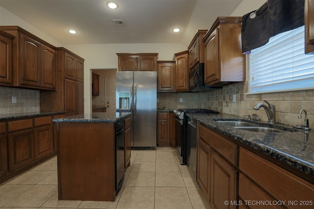 9904 N 102nd E Ave, Owasso, OK 74055 - kitchen with stainless steel fridge with ice dispenser, stove, a center island, tasteful backsplash, and dark stone countertops
