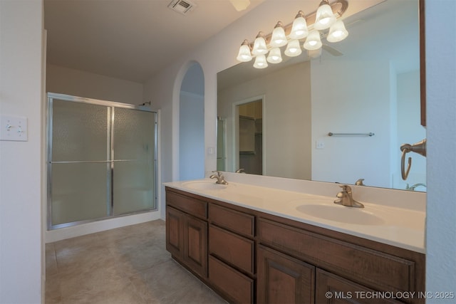 9904 N 102nd E Ave, Owasso, OK 74055 - bathroom with double vanity, a stall shower, tile patterned flooring, and a spacious closet