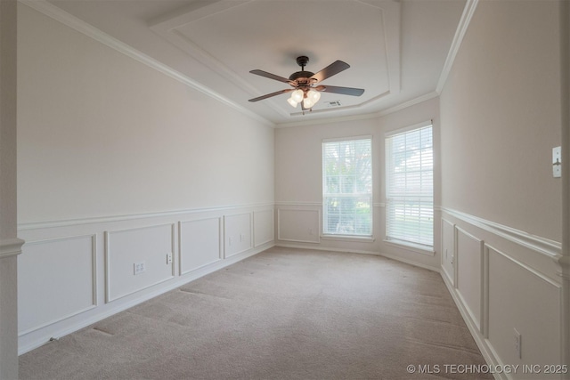 9904 N 102nd E Ave, Owasso, OK 74055 - spare room featuring a decorative wall, light colored carpet, a ceiling fan, ornamental molding, and a raised ceiling