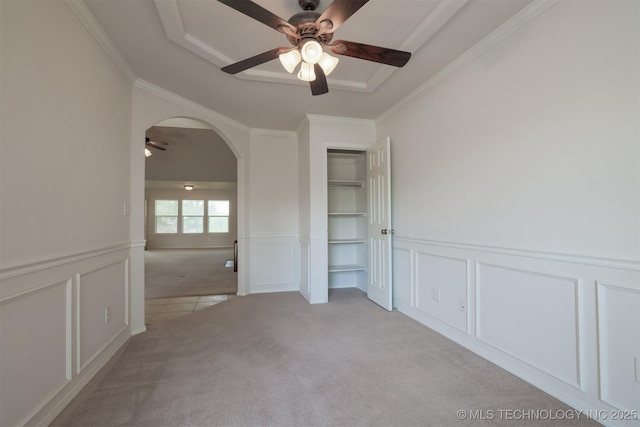 9904 N 102nd E Ave, Owasso, OK 74055 - unfurnished room with ceiling fan, a decorative wall, light carpet, arched walkways, and crown molding