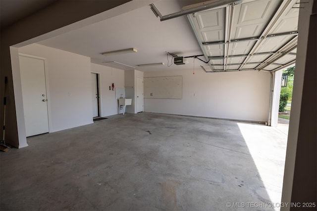 9904 N 102nd E Ave, Owasso, OK 74055 - garage with a garage door opener and a sink