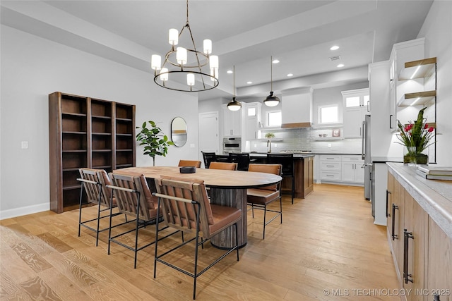 9613 E 119th Ct S, Bixby, OK 74008 - dining area featuring light wood-style floors, a chandelier, and recessed lighting