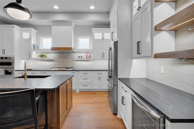 9613 E 119th Ct S, Bixby, OK 74008 - kitchen with open shelves, custom exhaust hood, decorative backsplash, dark countertops, and recessed lighting