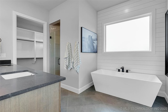 9613 E 119th Ct S, Bixby, OK 74008 - full bathroom featuring a freestanding bath, a shower stall, vanity, and wood walls