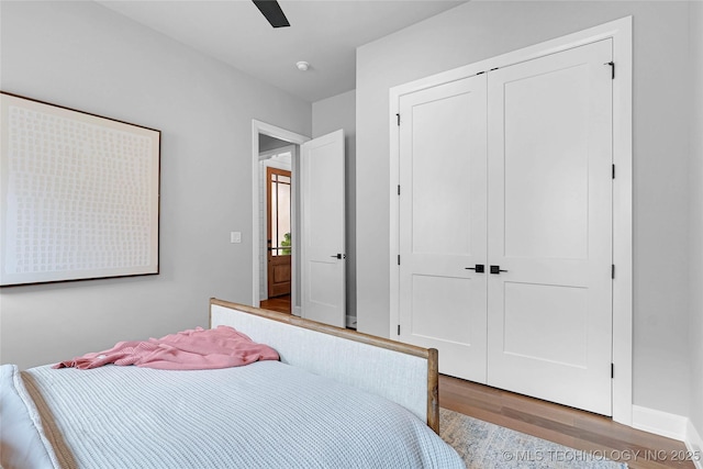 9613 E 119th Ct S, Bixby, OK 74008 - bedroom with wood finished floors, a closet, and a ceiling fan
