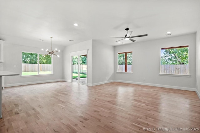 13236 E 4th Pl, Tulsa, OK 74108 - unfurnished living room with a chandelier, healthy amount of natural light, ceiling fan, light wood-type flooring, and recessed lighting