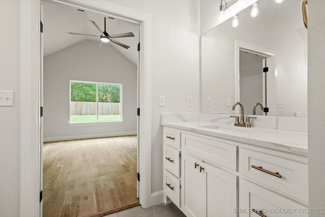 13236 E 4th Pl, Tulsa, OK 74108 - bathroom with a ceiling fan, vanity, lofted ceiling, and wood finished floors