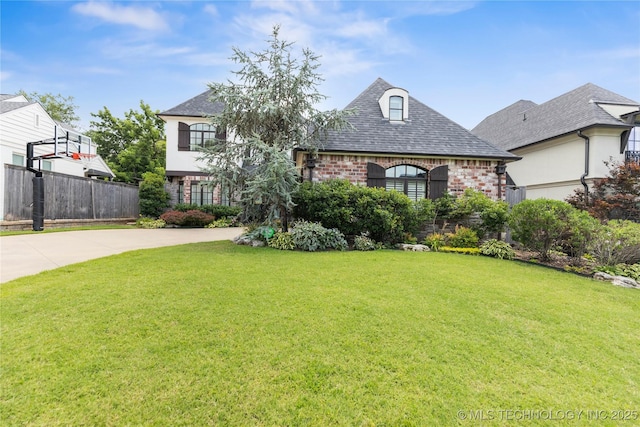 1536 E 35th Pl, Tulsa, OK 74105 - french country inspired facade with brick siding, concrete driveway, and a shingled roof