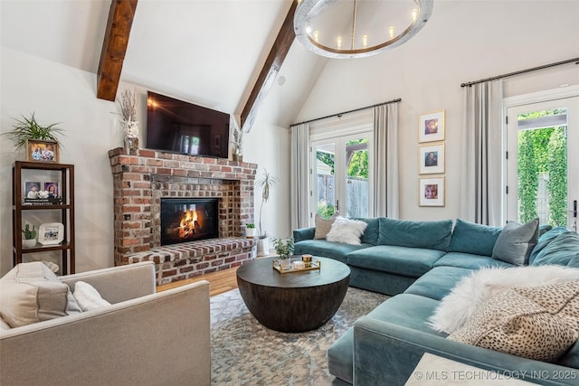 1536 E 35th Pl, Tulsa, OK 74105 - living room with plenty of natural light, a chandelier, high vaulted ceiling, a fireplace, and wood finished floors