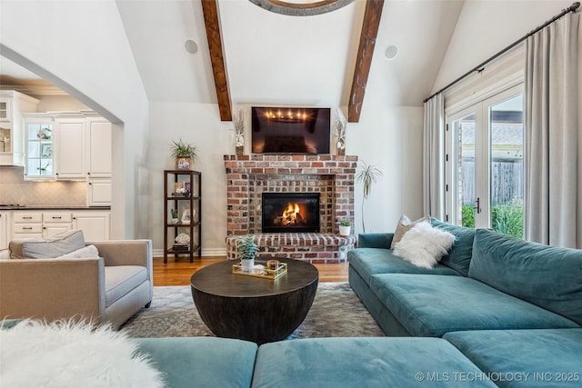 1536 E 35th Pl, Tulsa, OK 74105 - living room with wood finished floors, high vaulted ceiling, a brick fireplace, and beam ceiling