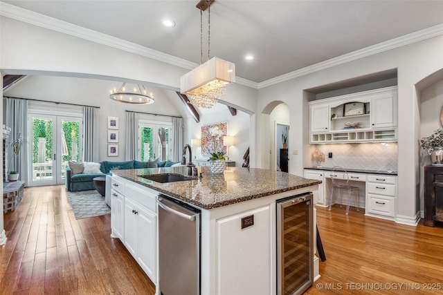 1536 E 35th Pl, Tulsa, OK 74105 - kitchen featuring beverage cooler, dishwasher, light wood-style floors, open floor plan, and ornamental molding