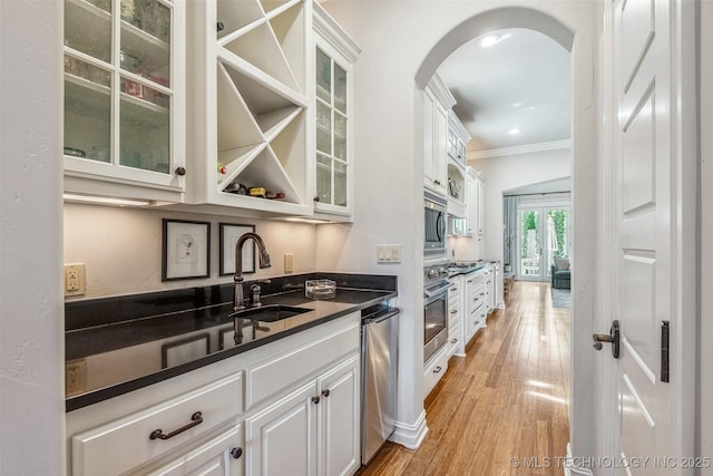 1536 E 35th Pl, Tulsa, OK 74105 - kitchen featuring dark countertops, ornamental molding, appliances with stainless steel finishes, arched walkways, and white cabinetry