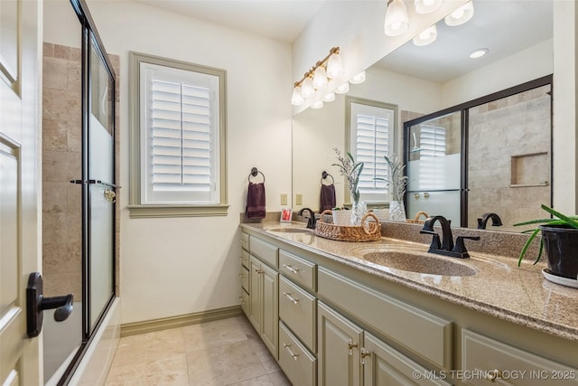 1536 E 35th Pl, Tulsa, OK 74105 - full bath featuring double vanity, tile patterned flooring, and bath / shower combo with glass door