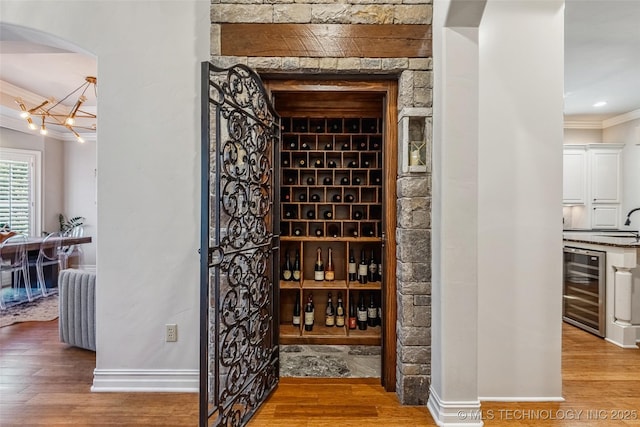 1536 E 35th Pl, Tulsa, OK 74105 - wine area with beverage cooler, ornamental molding, wood finished floors, and arched walkways