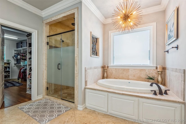 1536 E 35th Pl, Tulsa, OK 74105 - bathroom with a bath, a stall shower, a chandelier, a spacious closet, and crown molding