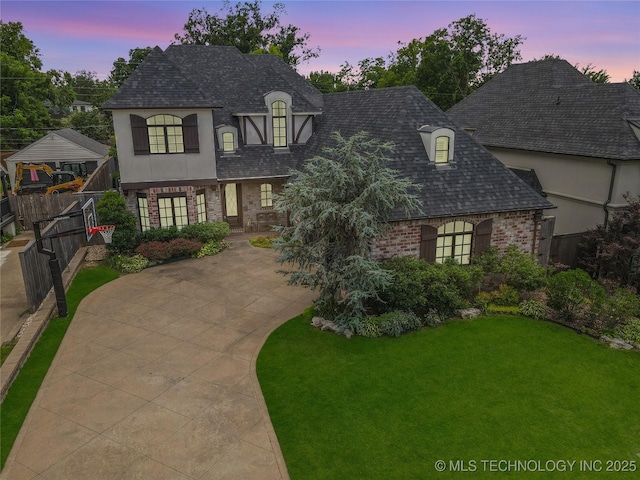 1536 E 35th Pl, Tulsa, OK 74105 - french country style house with brick siding, driveway, a shingled roof, and covered porch