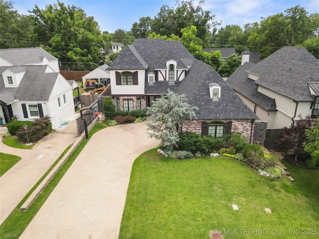1536 E 35th Pl, Tulsa, OK 74105 - french provincial home with brick siding, driveway, and roof with shingles