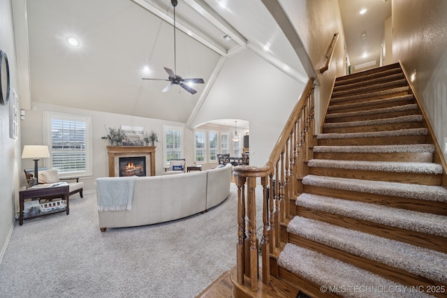 12225 S Glen Ct, Jenks, OK 74037 - carpeted living room featuring stairway, a ceiling fan, arched walkways, high vaulted ceiling, and plenty of natural light