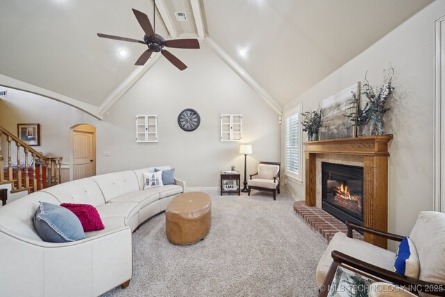 12225 S Glen Ct, Jenks, OK 74037 - living room with a glass covered fireplace, stairway, ceiling fan, beamed ceiling, and carpet floors