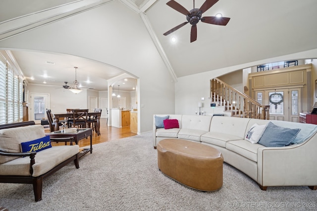 12225 S Glen Ct, Jenks, OK 74037 - living area featuring ceiling fan, arched walkways, stairs, high vaulted ceiling, and carpet