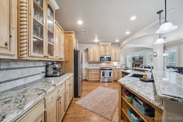 12225 S Glen Ct, Jenks, OK 74037 - kitchen with stainless steel appliances, ornamental molding, light brown cabinets, decorative backsplash, and arched walkways