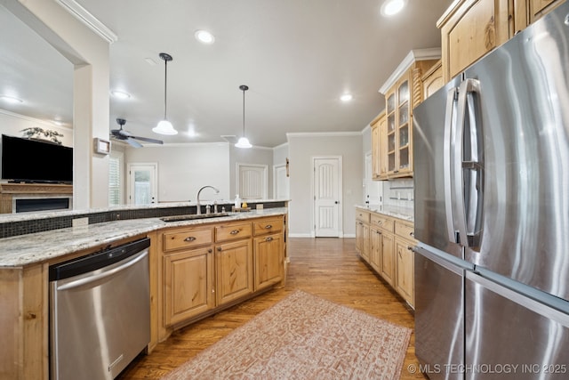 12225 S Glen Ct, Jenks, OK 74037 - kitchen with appliances with stainless steel finishes, ornamental molding, light wood-style floors, glass insert cabinets, and light stone countertops