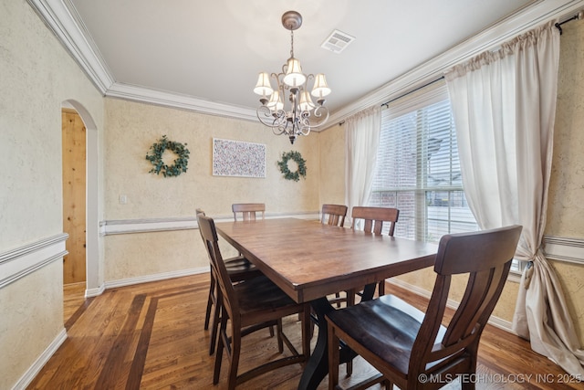 12225 S Glen Ct, Jenks, OK 74037 - dining space featuring ornamental molding, a chandelier, wood finished floors, arched walkways, and a textured wall