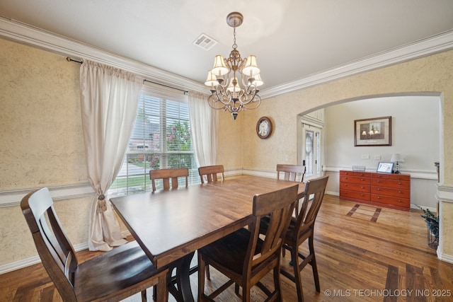 12225 S Glen Ct, Jenks, OK 74037 - dining area featuring ornamental molding, a chandelier, arched walkways, wood finished floors, and wallpapered walls