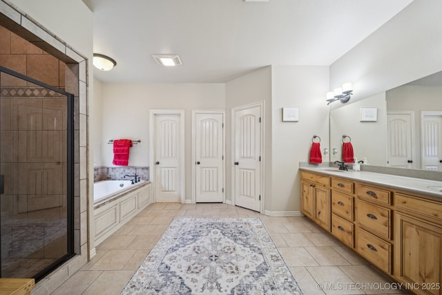 12225 S Glen Ct, Jenks, OK 74037 - bathroom featuring double vanity, a garden tub, a stall shower, and tile patterned floors