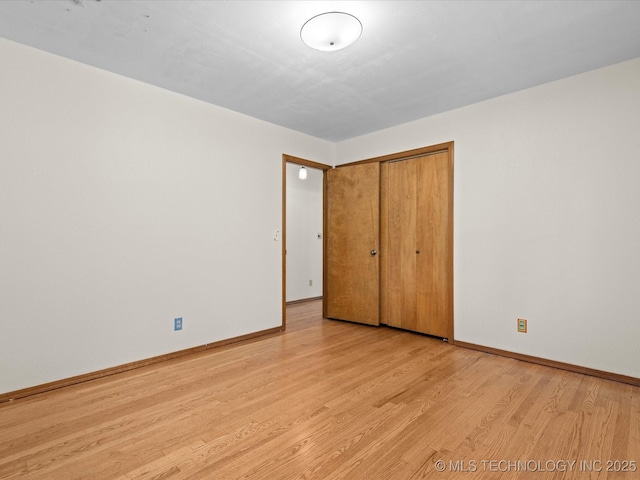 3321 Woodland Rd, Bartlesville, OK 74006 - unfurnished bedroom featuring light wood-type flooring and a closet