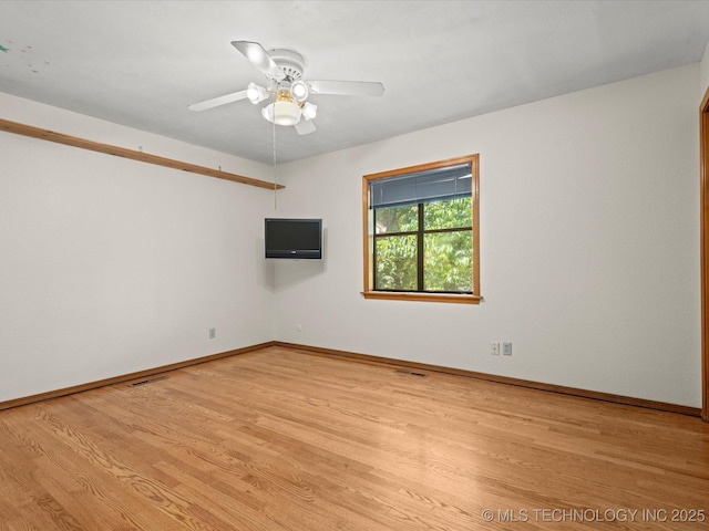 3321 Woodland Rd, Bartlesville, OK 74006 - spare room featuring light wood-style floors and a ceiling fan