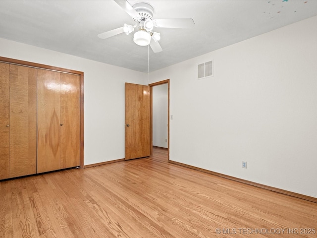 3321 Woodland Rd, Bartlesville, OK 74006 - unfurnished bedroom featuring light wood-style flooring, a closet, and ceiling fan
