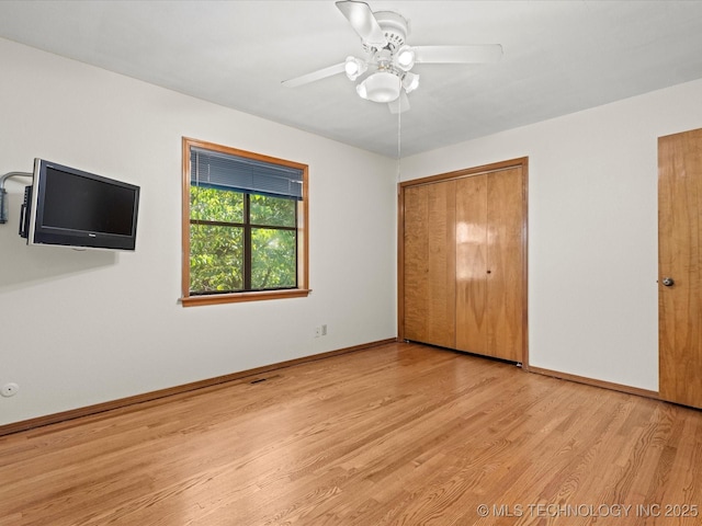 3321 Woodland Rd, Bartlesville, OK 74006 - unfurnished bedroom featuring wood finished floors and a ceiling fan