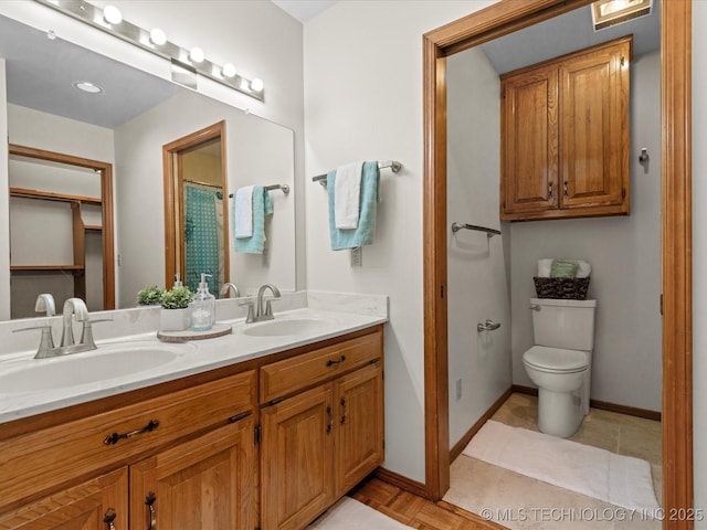 3321 Woodland Rd, Bartlesville, OK 74006 - bathroom featuring double vanity and toilet